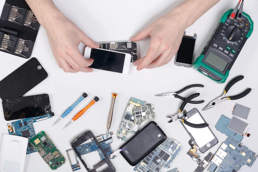 Skilled worker repairs cell phone